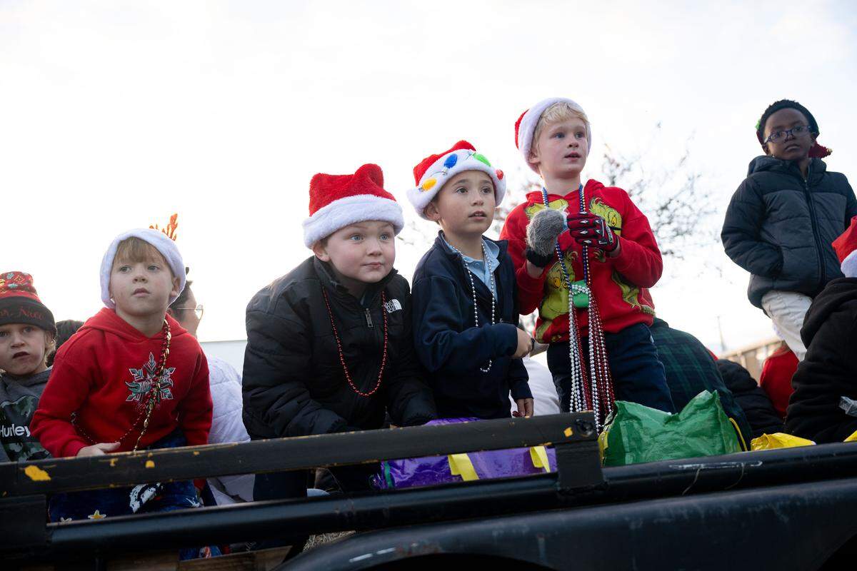 Children pass out candy from parade floats during the Champions Christmas Parade in Gulfport on Monday, Dec. 8, 2025.