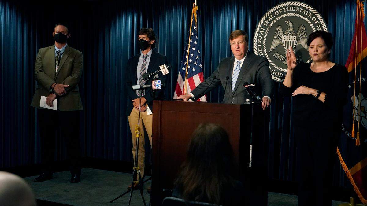 Gov. Tate Reeves, second from right, responds to a reporter’s question as sign language interpreter Amy Ainsworth, right, signs his answer during a news briefing regarding Mississippi’s COVID-19 response in Jackson, Miss., Thursday, Aug. 19, 2021. Also in attendance were State Health Officer, Dr. Thomas Dobbs, second from left, and Mississippi Emergency Management Agency Executive Director Stephen McCraney.