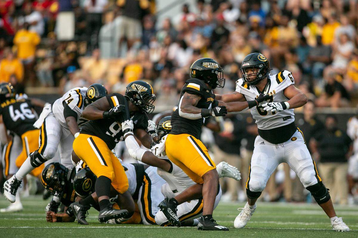 Southern Miss’s Michael Pleas Jr. grabs Grambling State’s Chris Chernak Jr. during the Southern Miss versus Grambling State game on Saturday, Sept. 11, 2021.