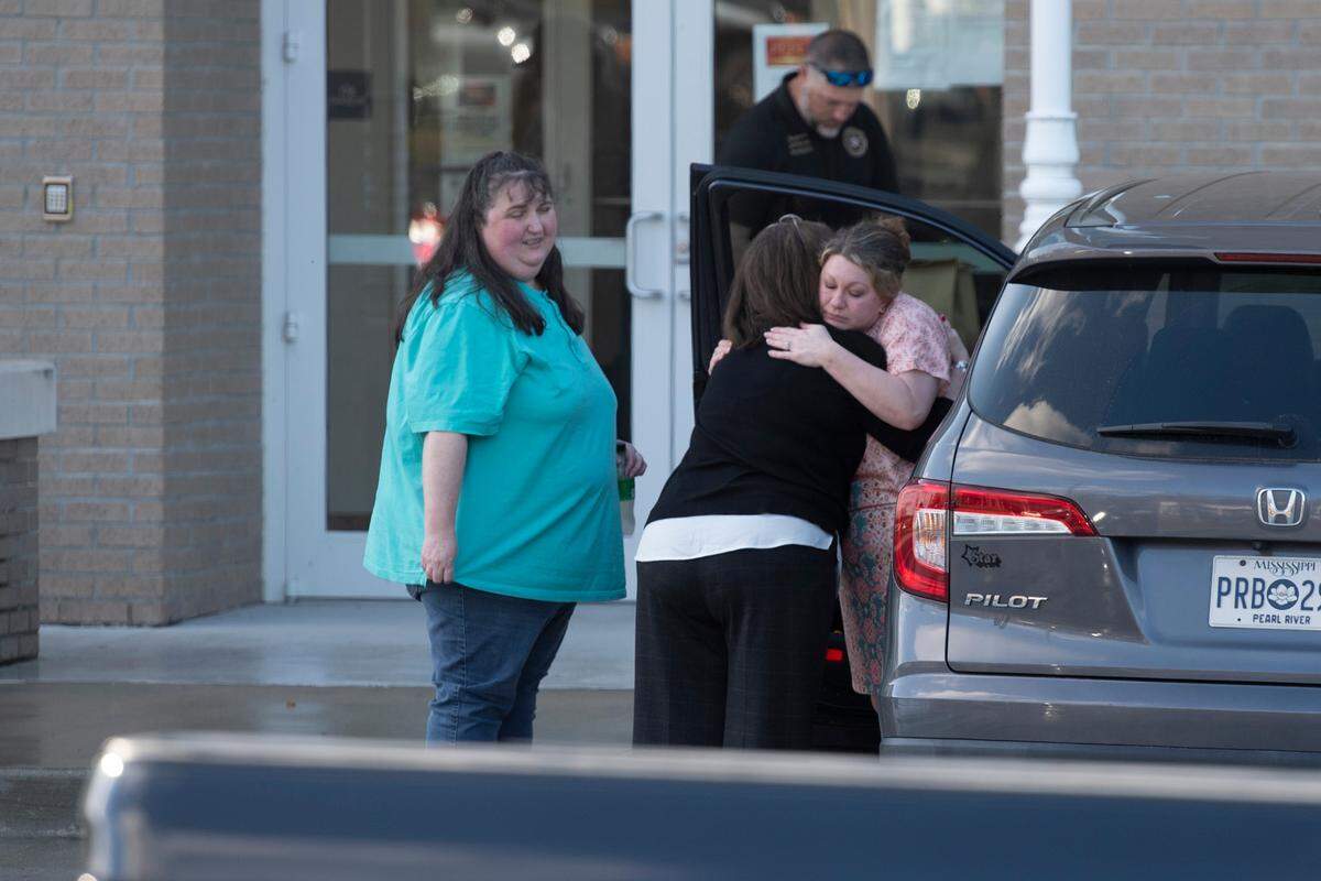 Family members of James Ray Saucier embrace outside the Pearl River County Courthouse Annex in Poplarville on Tuesday, Dec. 17, 2024, where Saucier was shot.