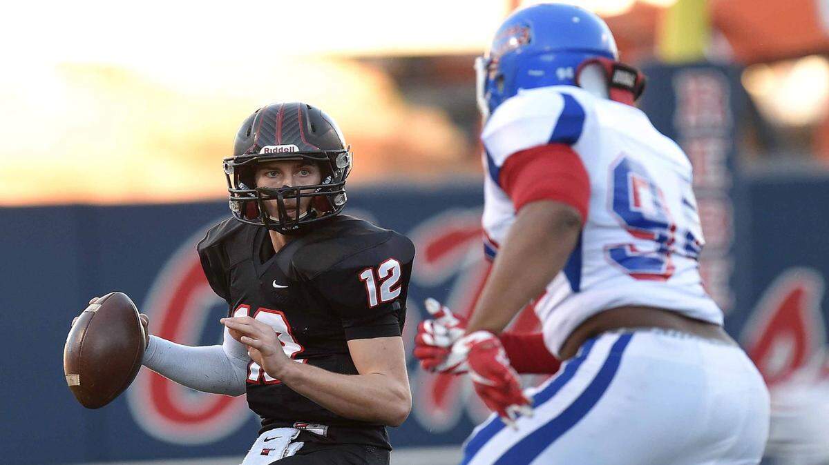CHRIS TODD/SPECIAL TO THE SUN HERALD/FILE 
 St. Stanislaus quarterback Myles Brennan (12) avoids Noxubee County defender Jeffery Simmons during the Class 4A state championship in December at Ole Miss' Vaught-Hemingway Stadium. Brennan earned an offer from the Rebels Friday night.