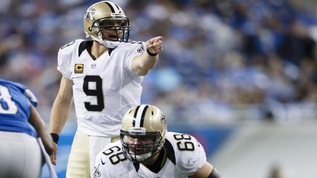 New Orleans Saints quarterback Drew Brees (9) gets set to run a play against the Detroit Lions during an NFL football game at Ford Field in Detroit, Sunday, Oct. 19, 2014. (AP Photo/Rick Osentoski)