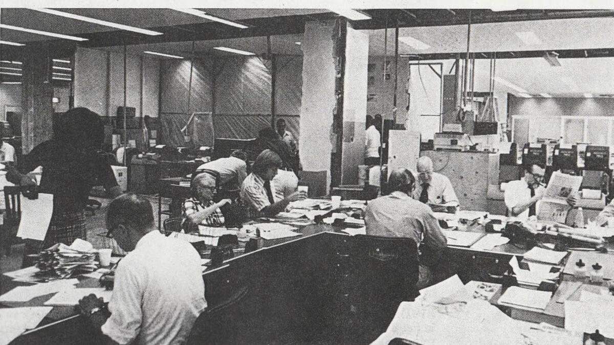 Jim Miller (with the longer hair) sits at the Baltimore Evening Sun’s copy desk in 1974, probably assembling a slug about Nixon’s resignation, he said.