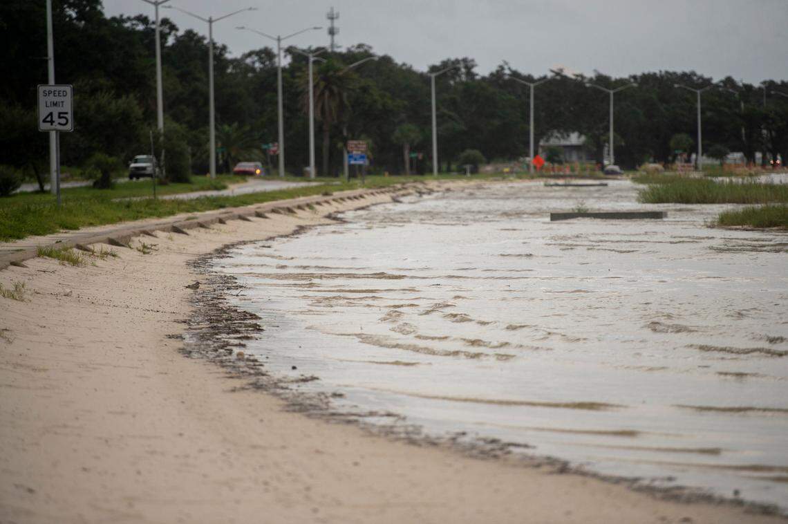 Storm surge rises, covering the beach along Highway 90 in Biloxi on Sunday.
