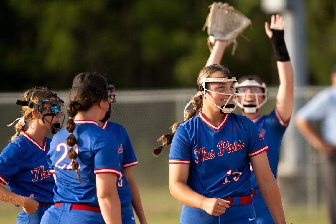 Pass Christian players celebrate Bristol Jones (15) getting her 500th strikeout Friday.