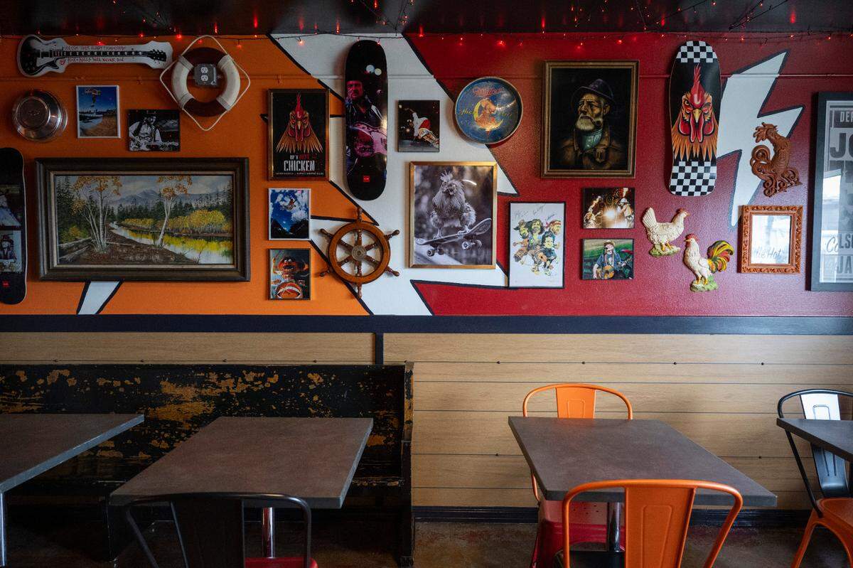 Dolly Parton, Willie Nelson and other country favorites grace the wall of fame at the new Rip ’N Hot Chicken in Biloxi.