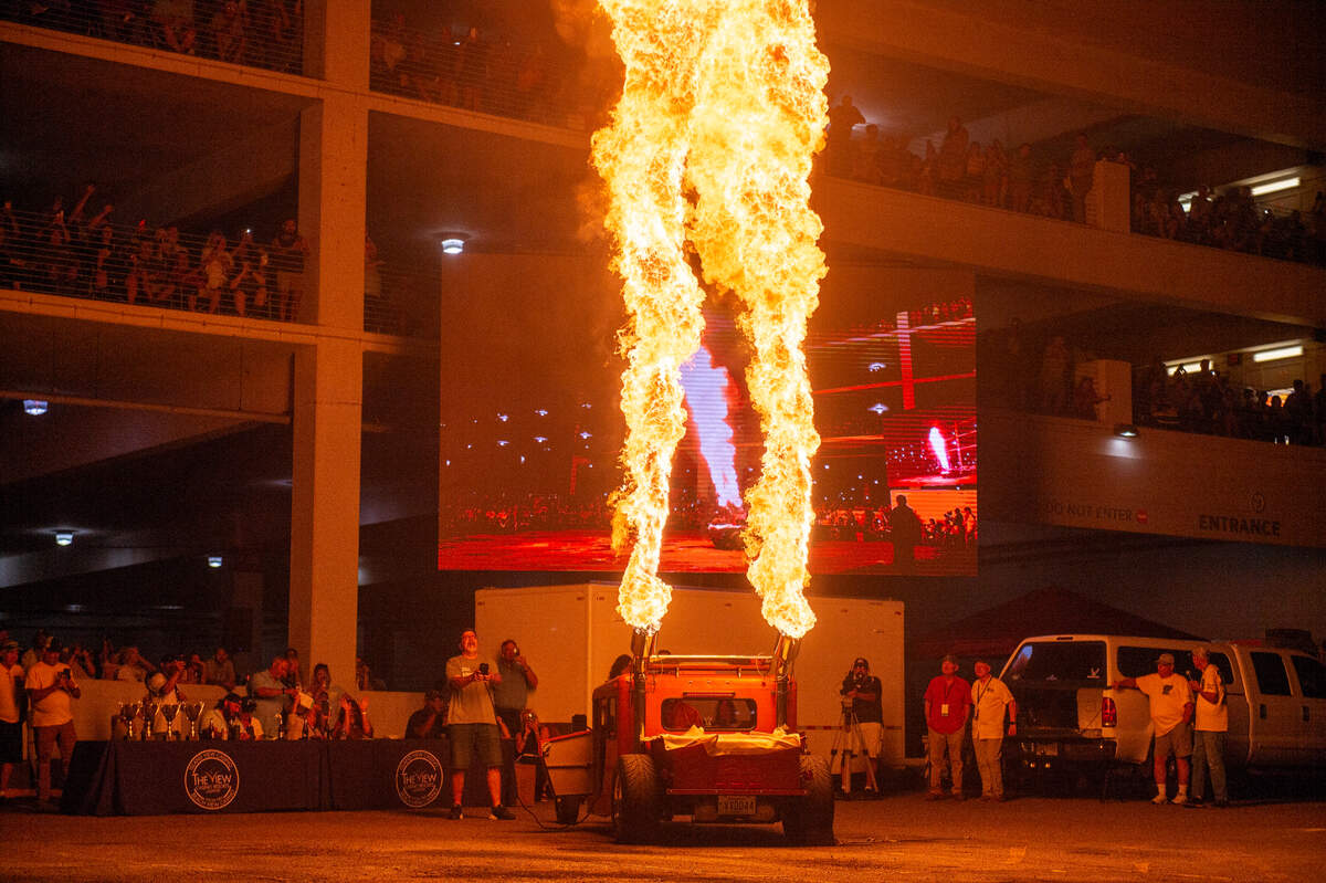 Harlyn Mallett watches flames shoot out of his 1979 Jeep Postal during a flame throwing competition, where drivers compete to see which car can produce the biggest flames, at Island View Casino in Gulfport during Cruisin’ The Coast on Tuesday, Oct. 3, 2023.