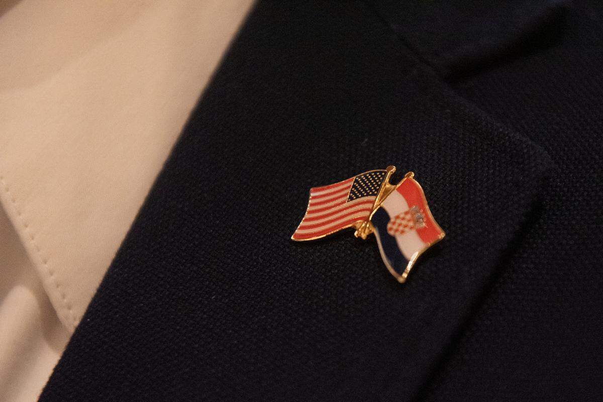 A member of the Croatian American Cultural Center wears a pin with the American and Croatian flags while waiting for Croatian President Zoran Milanović to arrive at the Croatian American Cultural Center in Biloxi, Miss. on Friday, Sept. 22, 2023.