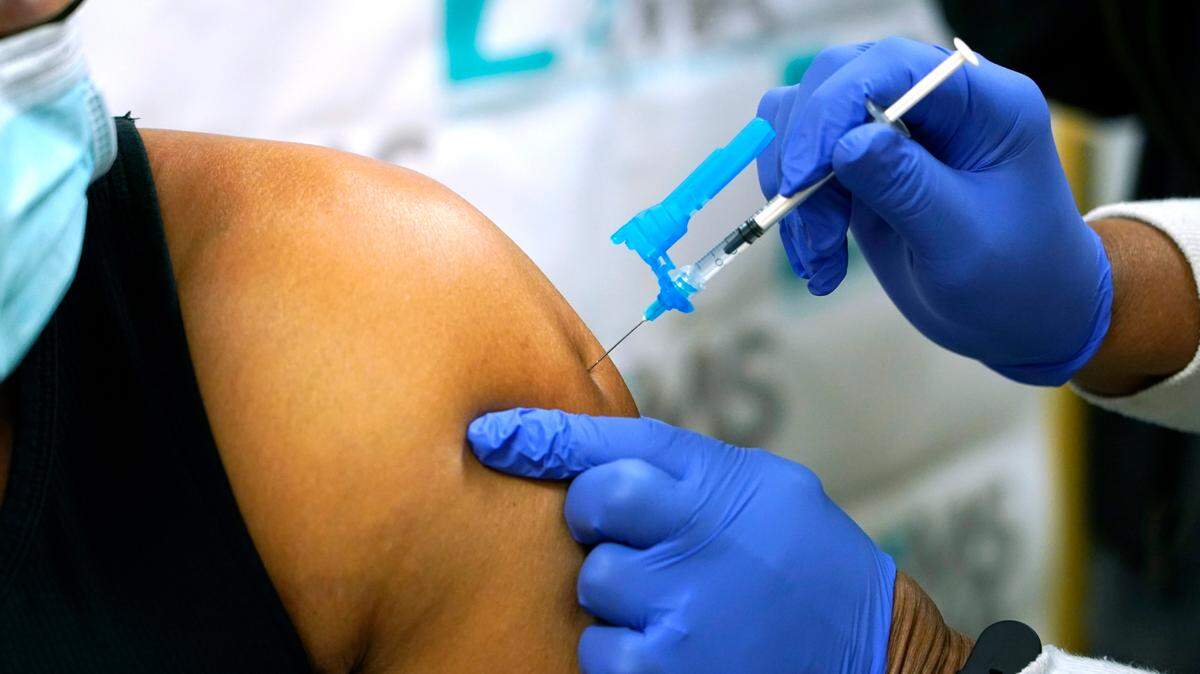 Dr. Timothy Quinn, owner of Quinn Health Care, left, receives the first round of the Pfizer COVID vaccination, along with other state medical leaders in conjunction with the Mississippi State Department of Health, Wednesday, Dec. 16, 2020, in Ridgeland, Miss. The 10 physicians received their inoculations as a group in an effort to encourage residents to get vaccinated when presented the opportunity.