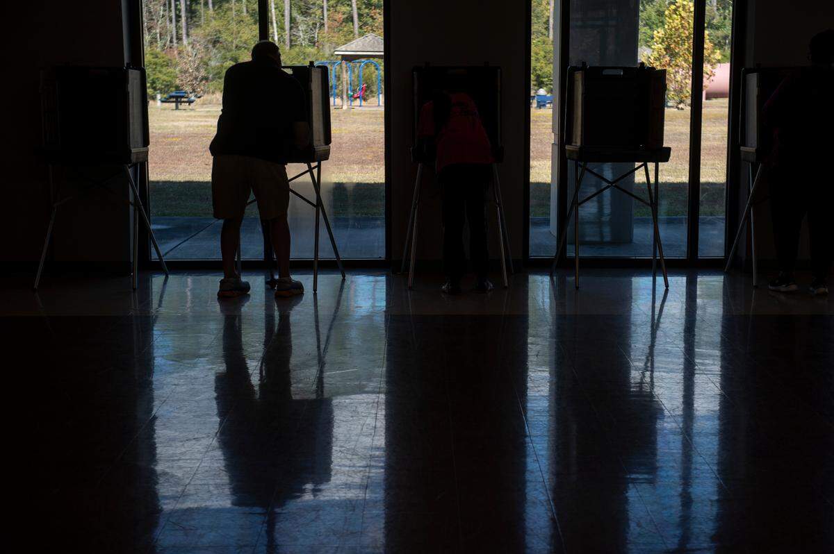 A voter casts a ballot at Orange Grove Community Center in Harrison County Tuesday. The election is for state and county offices.