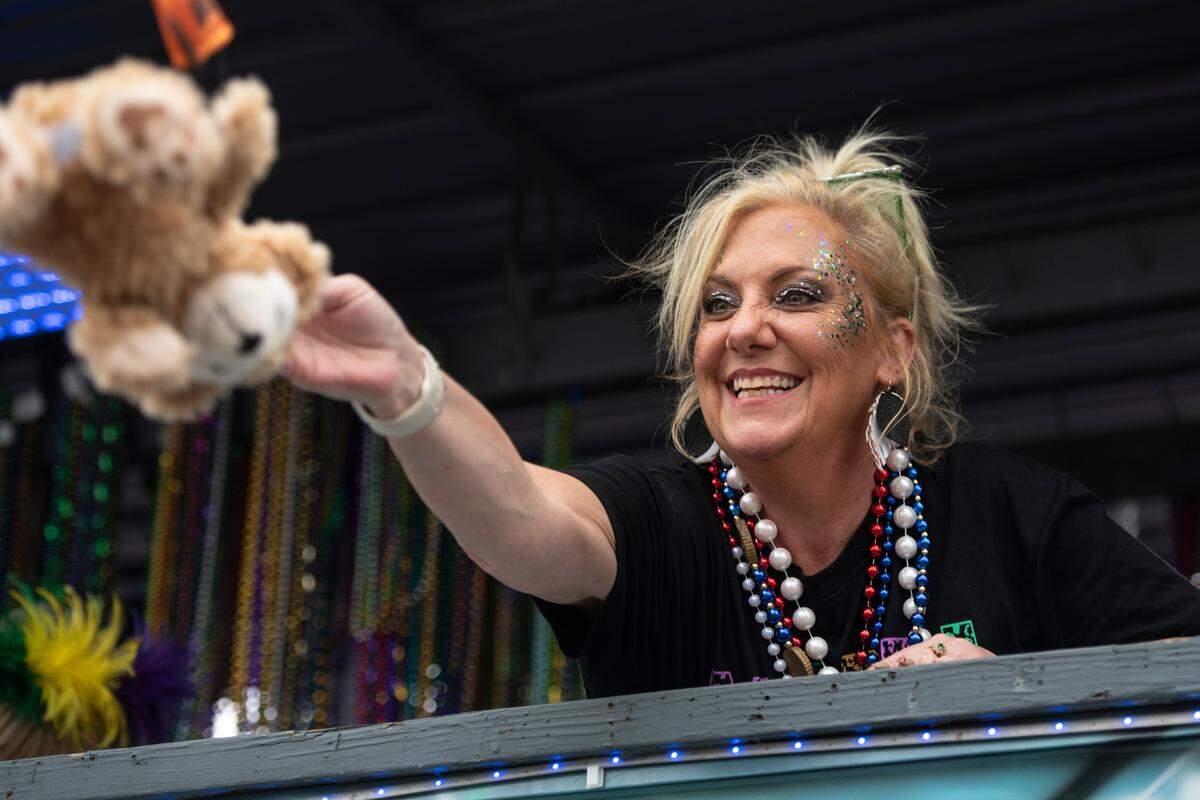 A float rider throws a teddy bear to the crowd during the Gulf Coast Carnival Association Mardi Gras parade in Biloxi on Tuesday, March 4, 2025.