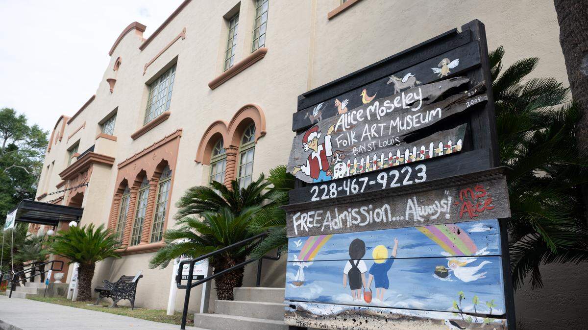 A sign stands outside the Alice Moseley Folk Art Museum in Bay St. Louis on Wednesday, Aug. 27, 2025. The Historic L&N Train Depot building in Bay St. Louis houses several local attractions and offices, including the Hancock County Tourism Development Bureau.