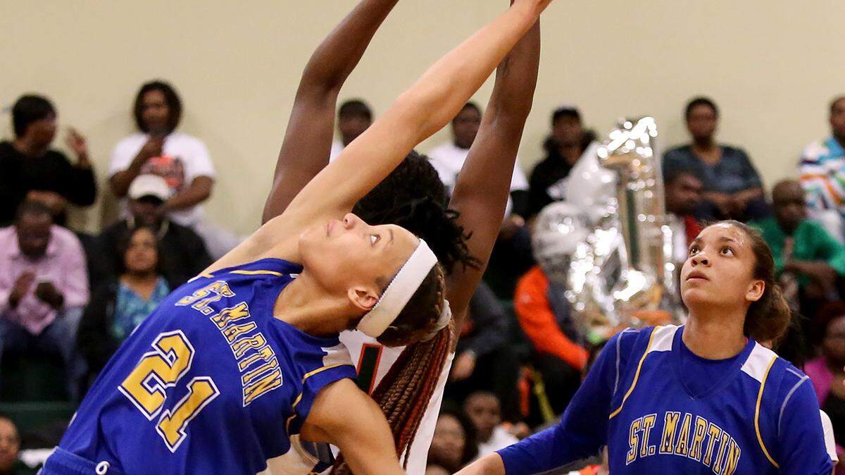 AMANDA McCOY/SUN HERALD 
 St. Martin's Daphane White, 21, reaches back for a rebound snagged by West Harrison's Ameshya Williams on Friday, February 5, 2016, at West Harrison High.