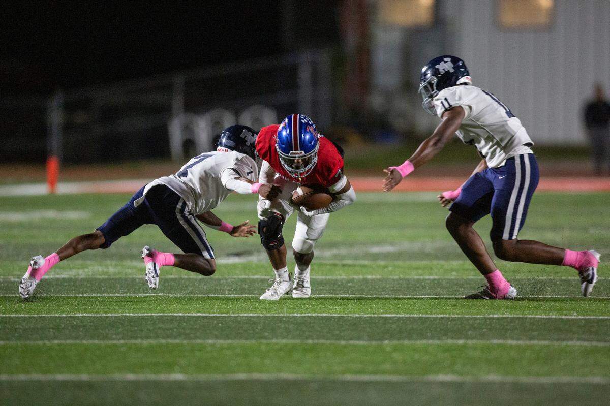Pass Christian’s Anthony James gets tackled as he runs the ball down the field during a game against Moss Point at Pass Christian High School in Pass Christian on Friday, Oct. 13, 2023.