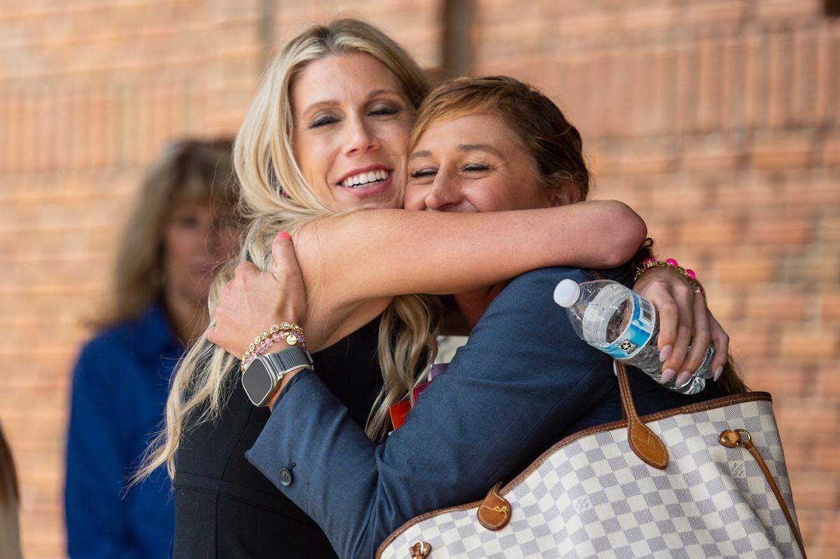 Heather Wyatt hugs her attorney, Kimberly Papania, as she leaves Jackson County Chancery Court on Thursday after a hearing over a judge’s temporary order preventing her from posting on social media.