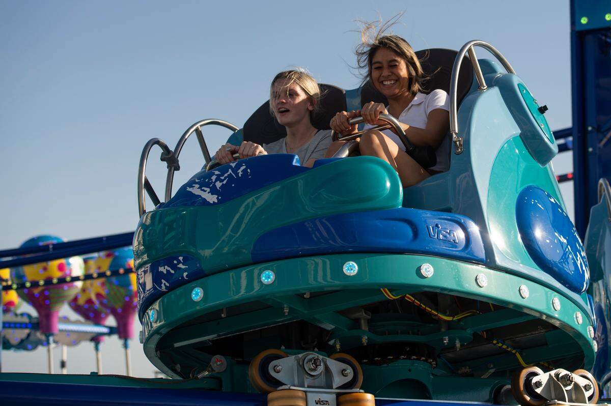 Riders react as they ride the Rolling Thunder rollercoaster ride during the grand opening of Paradise Pier amusement park at Margaritaville in Biloxi on Friday, March 3, 2023.