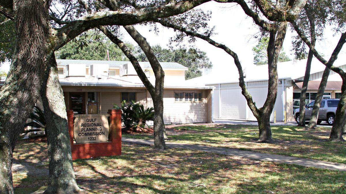 ANITA LEE/SUN HERALD 
 The former Gulf Regional Planning Commission office sits on one of Pass Road's few oak-shaded lots. The Gulfport City Council has agreed that property owner Dennis Barber can remove five trees for parking, including the two on each side of the walkway and two pictured nearest the adjoining business.
