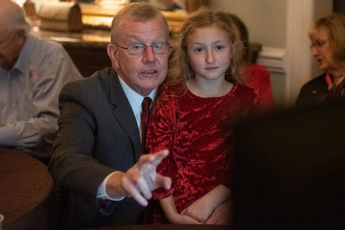 Jackson County Sheriff Mike Ezell, the Republican candidate for Mississippi’s 4th Congressional District, and his granddaughter, Sydney, sit around a television as results come in on election night at Grand Magnolia Ballroom and Suites in Pascagoula on Tuesday, Nov. 8, 2022.