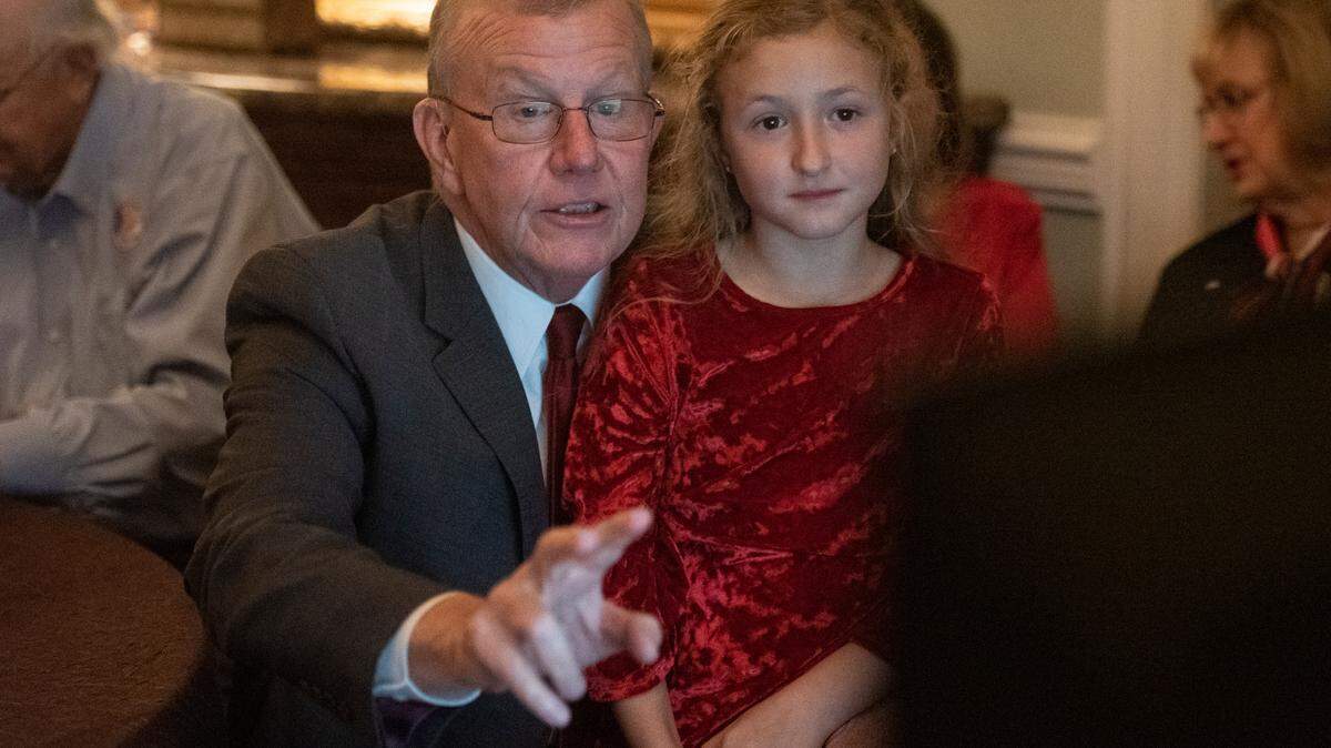 Jackson County Sheriff Mike Ezell, the Republican candidate for Mississippi’s 4th Congressional District, and his granddaughter, Sydney, sit around a television as results come in on election night at Grand Magnolia Ballroom and Suites in Pascagoula on Tuesday, Nov. 8, 2022.