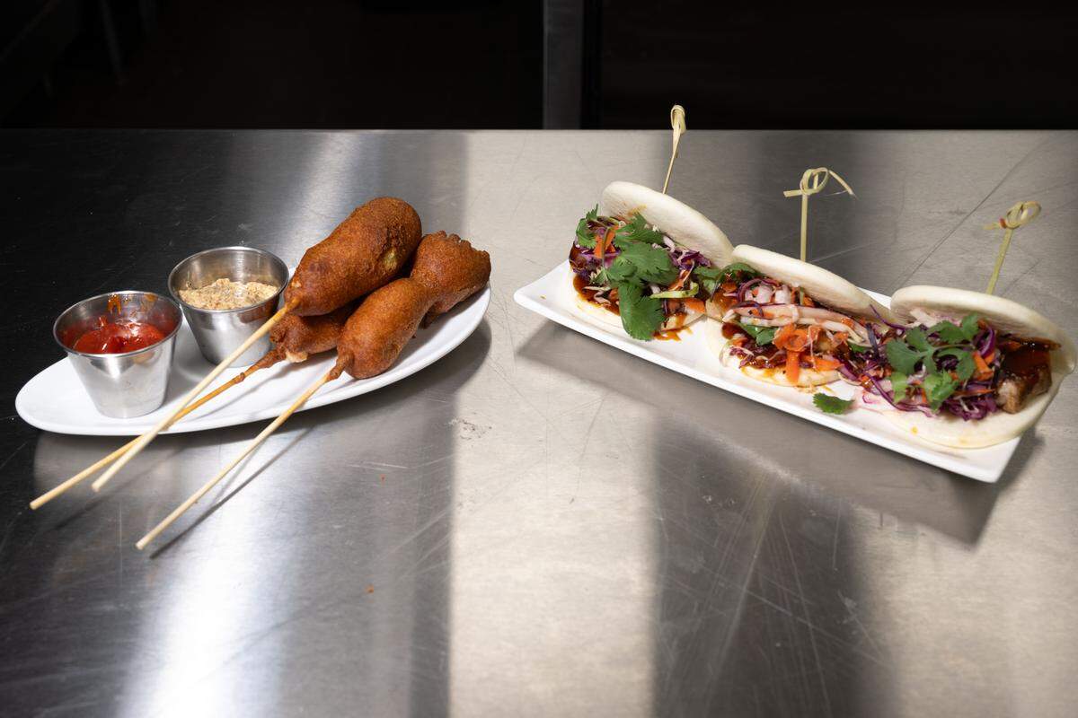 Shrimp corn dogs, left, and Korean pork belly sliders, right, await at the new Chandeleur Depot Brewpub in Pascagoula