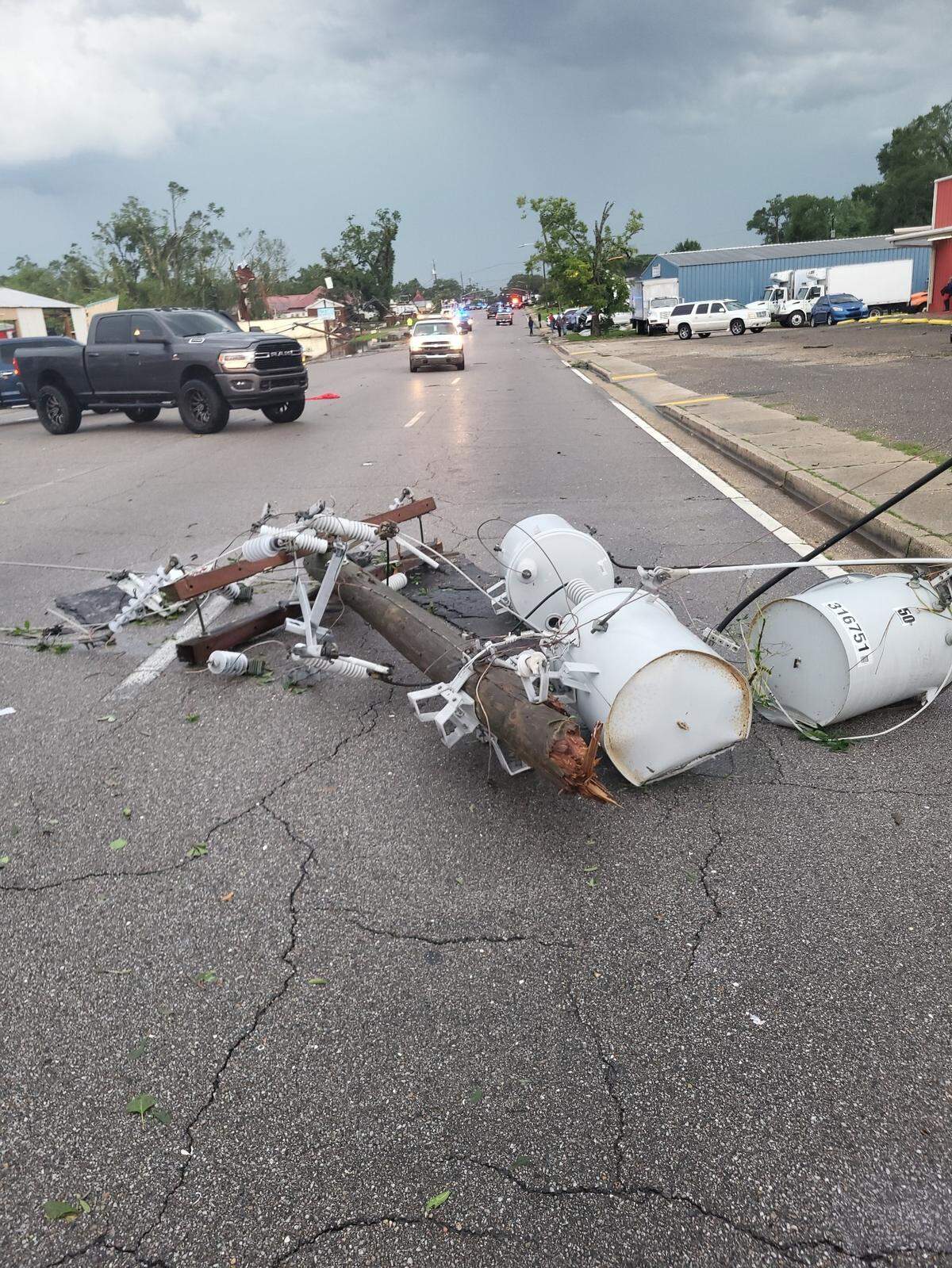 A blown power transformer is seen in the street after a tornado tore through Moss Point on June 19, 2023.
