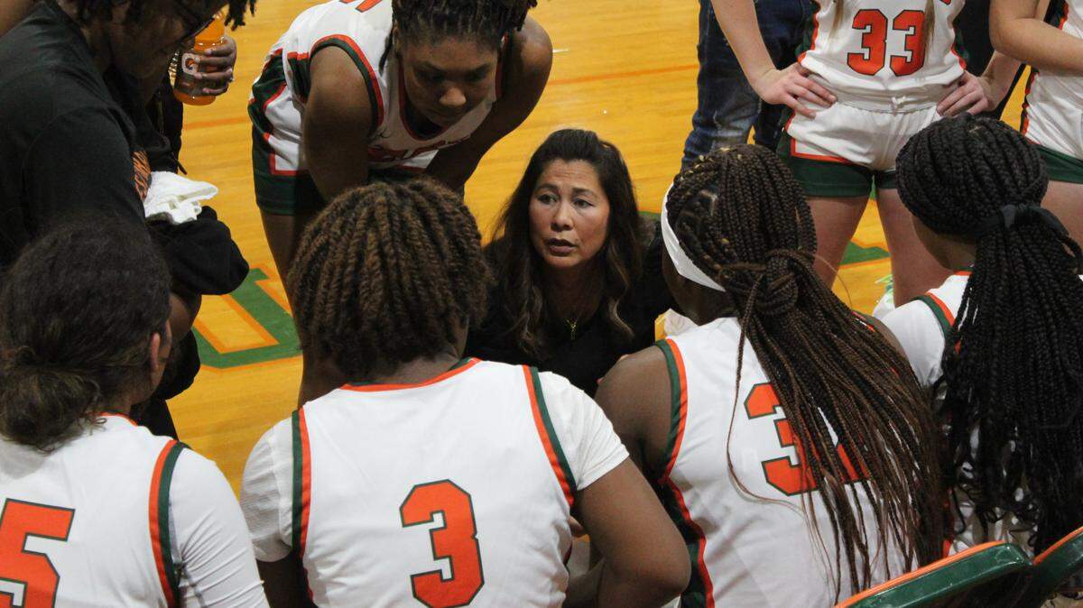 West Harrison girls basketball coach Patty Norwood talks to her team during a timeout.