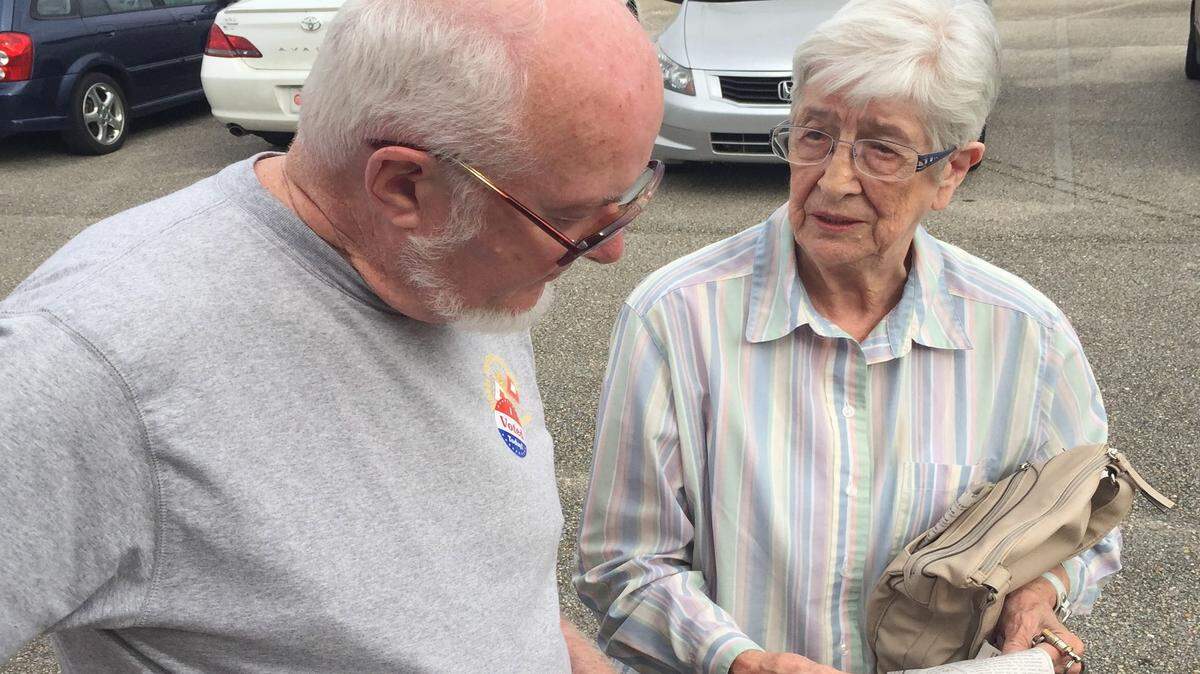 JOHN FITZHUGH/SUN HERALD 
 Neighbors Bob Kilroy, left, and Pat Lawson look over a sample ballot showing how to vote on Initiative 42 at Gulfport precinct 5 at Mississippi Gulf Coast Studios on Tuesday Nov. 3, 2015. Both agreed the ballot was confusing.