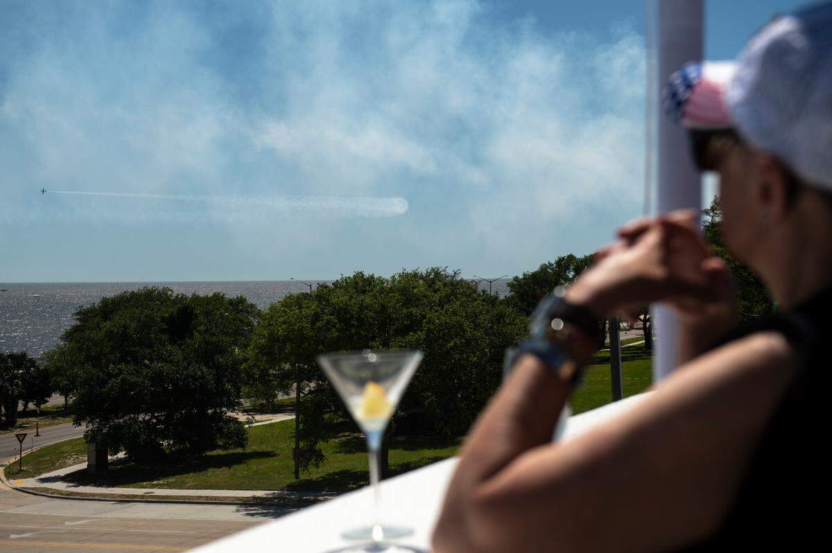 Fans of the U.S. Air Force Thunderbirds watch them from the roof of the White House Hotel during a practice for the Thunder Over the Sound airshow on Friday, April 28, 2023.