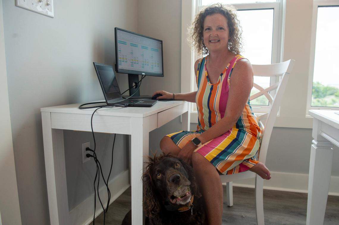 Emily Schaumburg poses for a portrait at her home office in Bay St. Louis on Friday, May 23, 2025. Schaumburg works remotely as a tax advisor for Entergy, a New Orleans utility company, which allows her to spend more time with her dogs and kids.