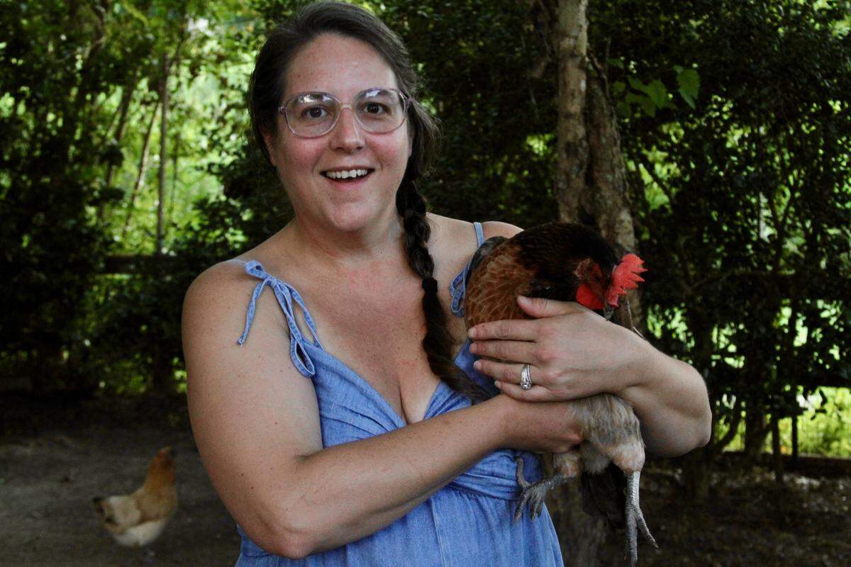 Jamie Stebly holds one of her eight backyard chickens at her Gulf HIlls subdivision home in Jackson County. She and husband Chris Stebly had to hire an attorney and fight to keep the chickens in Jackson County, while the neighboring city of Ocean Springs has more lenient rules for keeping chickens.