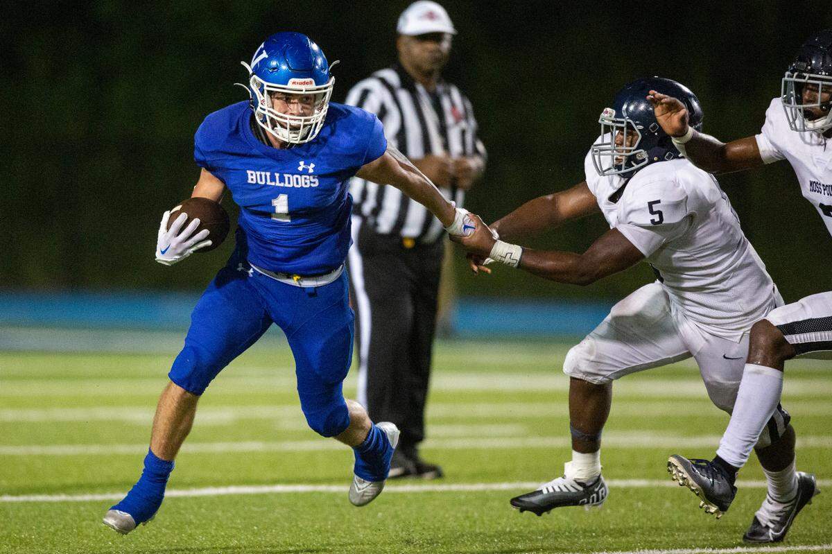 Vancleave’s John Peterson (1) tries to break away as Moss Point’s Kaleb Raston (5) holds him back during a game against Moss Point at Vancleave Football Stadium in Vancleave on Friday, Sept. 9, 2022.