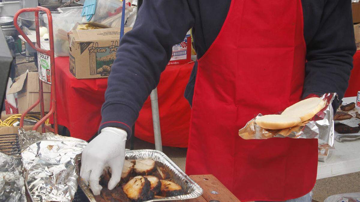 TIM ISBELL/SUN HERALD/FILESteven Ramsey dishes up barbecue chicken and pork chops during a previous BBQ Throwdown in D'Iberville. This year's BBQ Throwdown will open from 9 a.m. to 4 p.m. Saturday at the D'Iberville Civic Center.