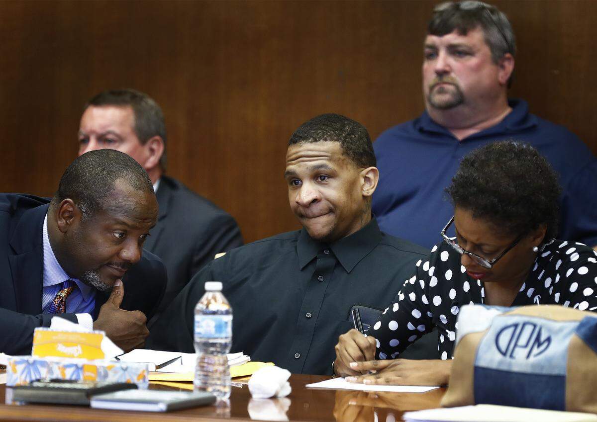 Defendant Quinton Tellis, center, looks on as the jury goes to deliberate his case, as his defense attorneys Alton Peterson, left, and Darla Palmer  confer during the retrial of Quinton Tellis in Batesville, Mississippi on Sunday, Sept. 30, 2018. Tellis is charged with burning 19-year-old Jessica Chambers to death almost three years ago on Dec. 6, 2014. Tellis has pleaded not guilty to the murder.