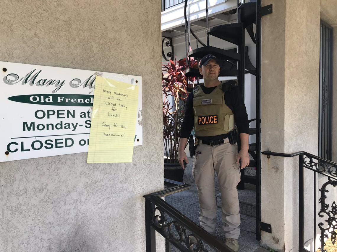 FDA agent Shane Davis stands next to a sign saying Biloxi’s iconic Mary Mahoney’s Old French House Restaurant is closed for lunch on Tuesday, Nov. 19, 2019.