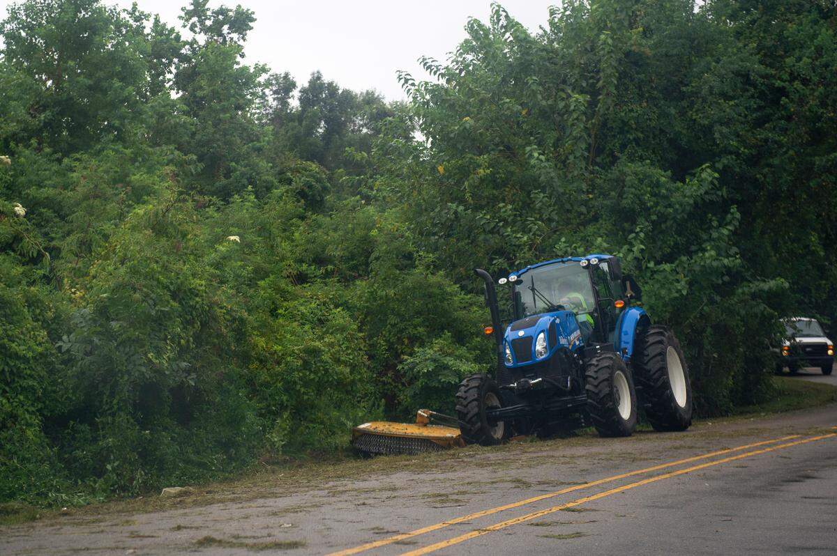 A city of Biloxi vehicle mows the right of way along Iris Street, where the city school district and Broadwater Development LLP own property being cleared for better visibility. Homeless camps on some of the land also have been removed.