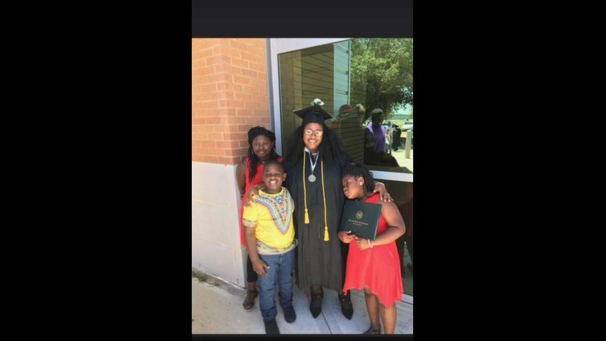 Shermarion Miner, his siblings and mom, Tawanda Carter, are pictured after Carter earned her master’s degree in social work.