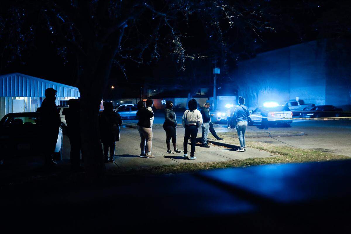 A crowd gathers and waits for hours as officials process the scene where a man was shot and killed by a Harrison County deputy Friday, Jan. 15, 2021. No details about the shooting have yet been released by the Mississippi Bureau of Investigations who took over the case.