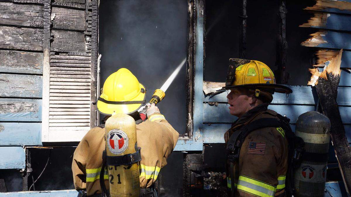 COURTESY PAT SULLIVANFirefighters battle a house fire in Long Beach that was caused by a 3-year-old playing with a lighter Wednesday afternoon.