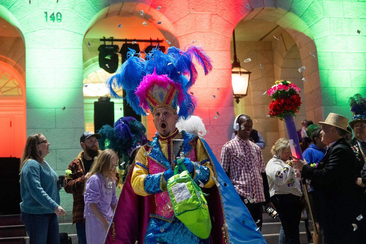 A parade attendee sets off a bundle of confetti during a 12th Night Celebration in Biloxi on Monday, Jan. 5, 2026.