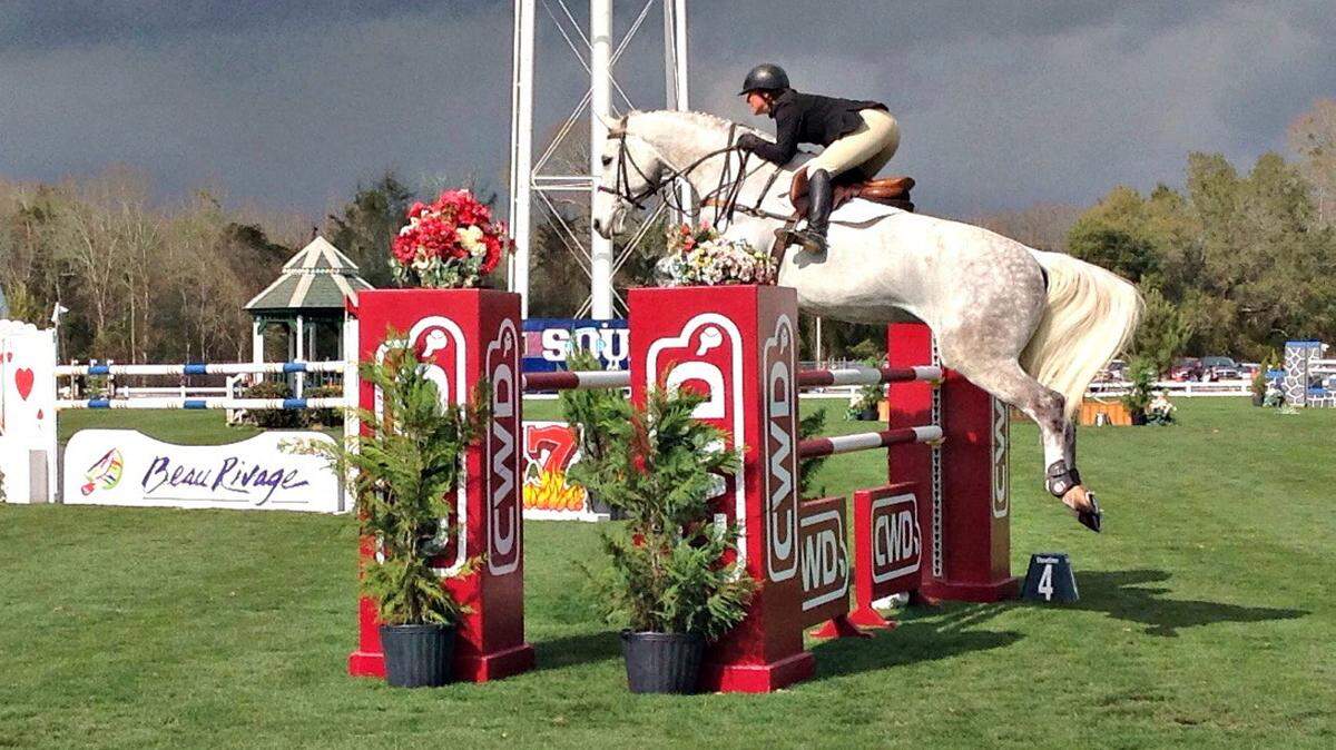 MARY PEREZ/SUN HERALDA horse and rider jump the rails directly in front of the bleachers at the Gulf Coast Winter Classic Sunday at the Harrison County Fairgrounds. Admission is free and the event continues for three more weeks in South Mississippi.
