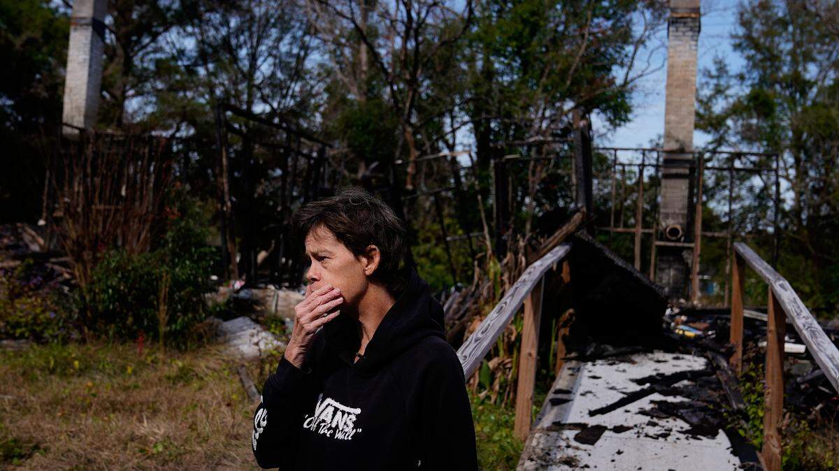 Lisa McGuire stands near her former walkway last year, as she describes a fire that engulfed her home, killing her two dogs, in a Prichard, Ala., neighborhood with a history of severe water loss. When a neighbor called her about the fire, she said she rushed home to find firefighters with an empty hose attached to a hydrant.