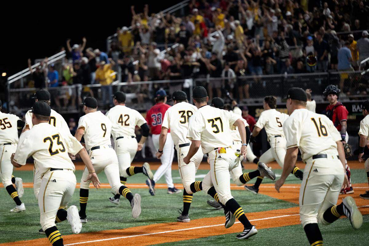 Southern Miss players rush the field as fans cheer after a walk-off score to win a baseball game at Pete Taylor Park in Hattiesburg on March 10.