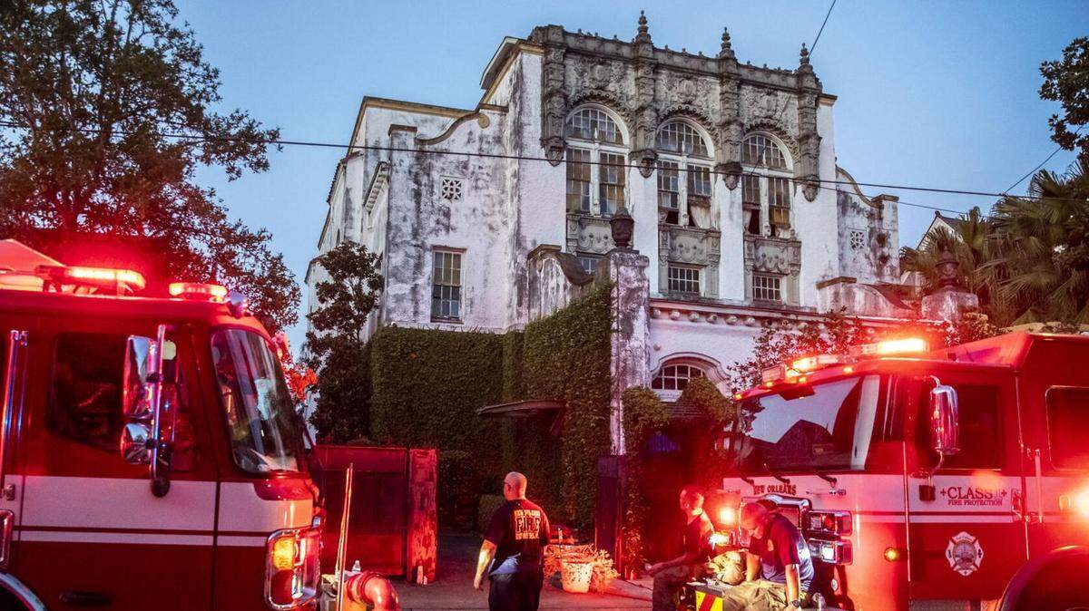 New Orleans firefighters rest after dousing a fire Wednesday night at a house reportedly owned by Beyoncé in the 1500 block of Harmony Street.