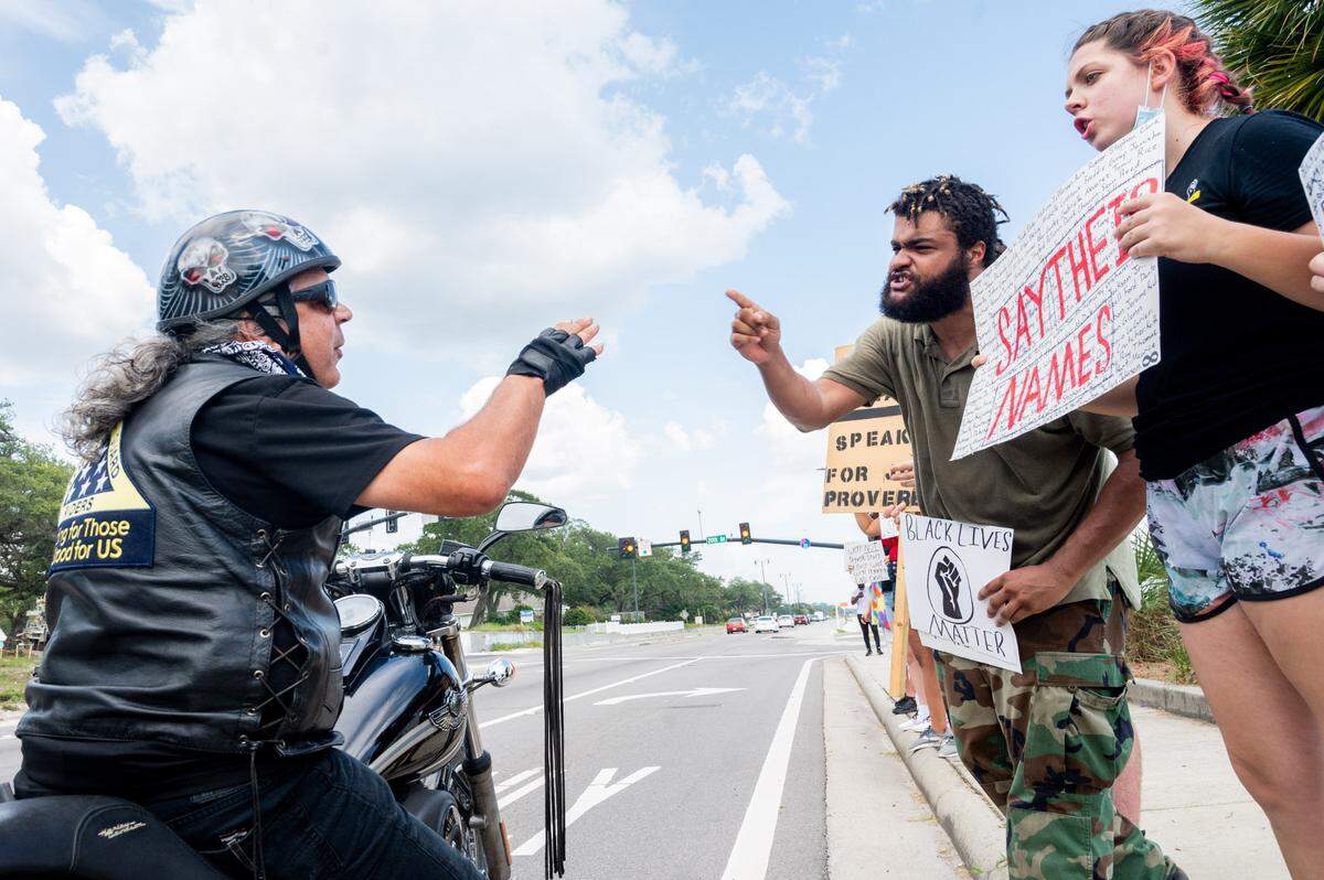 Jonathan Curry and Olivia Ruiz debate with a man who pulled over to confront the teenagers about their motives to protest on Saturday, Sept. 5, 2020.