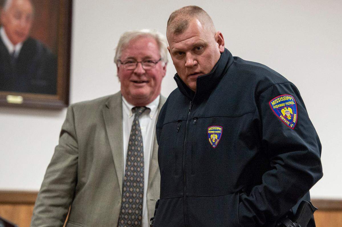 Mississippi Highway Patrol Master Sgt. Dale Decamp and his attorney, Tim Holleman, leave the courtroom after a probable cause hearing at Harrison County Circuit Court in Gulfport on Thursday, Feb. 17, 2022. Decamp is potentially facing a misdemeanor assault charge.