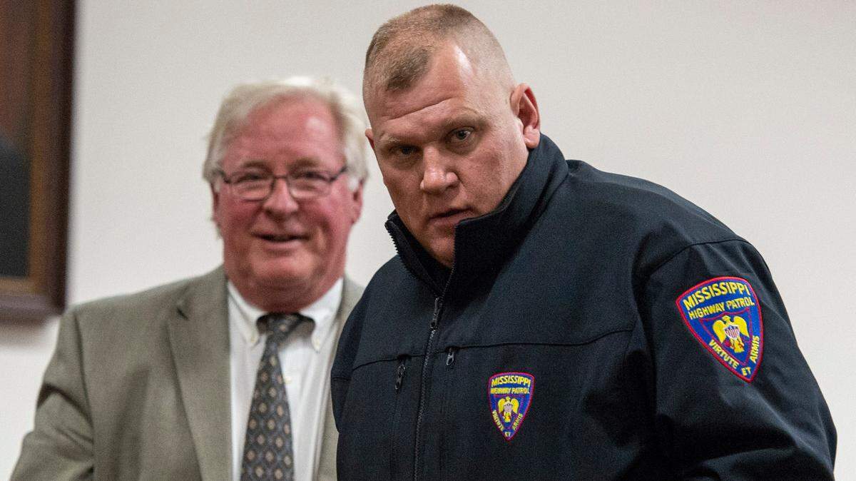Mississippi Highway Patrol Master Sgt. Dale Decamp and his attorney, Tim Holleman, leave the courtroom after a probable cause hearing at Harrison County Circuit Court in Gulfport on Thursday, Feb. 17, 2022. Decamp is potentially facing a misdemeanor assault charge.