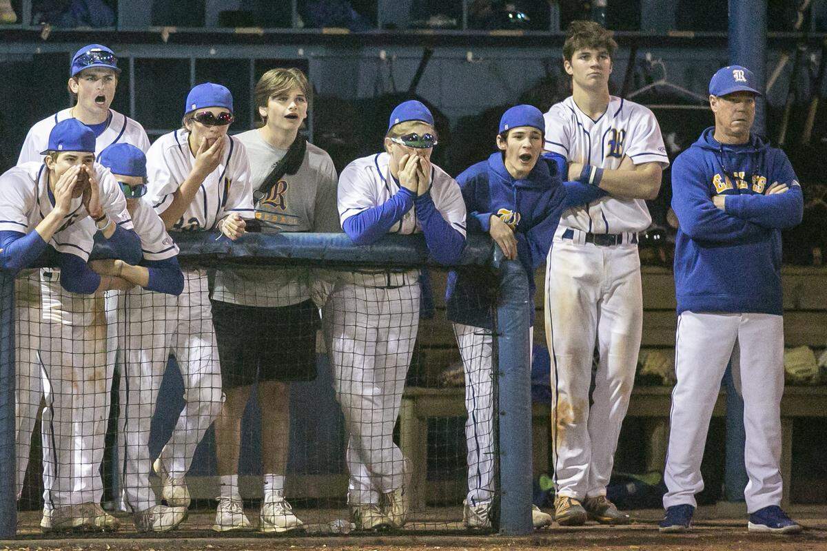 Resurrection coach Johnny Olsen watches the game along side his players in the dugout during a game against Bayside Academy at MCC Park in Pascagoula on Thursday, March 10, 2022.