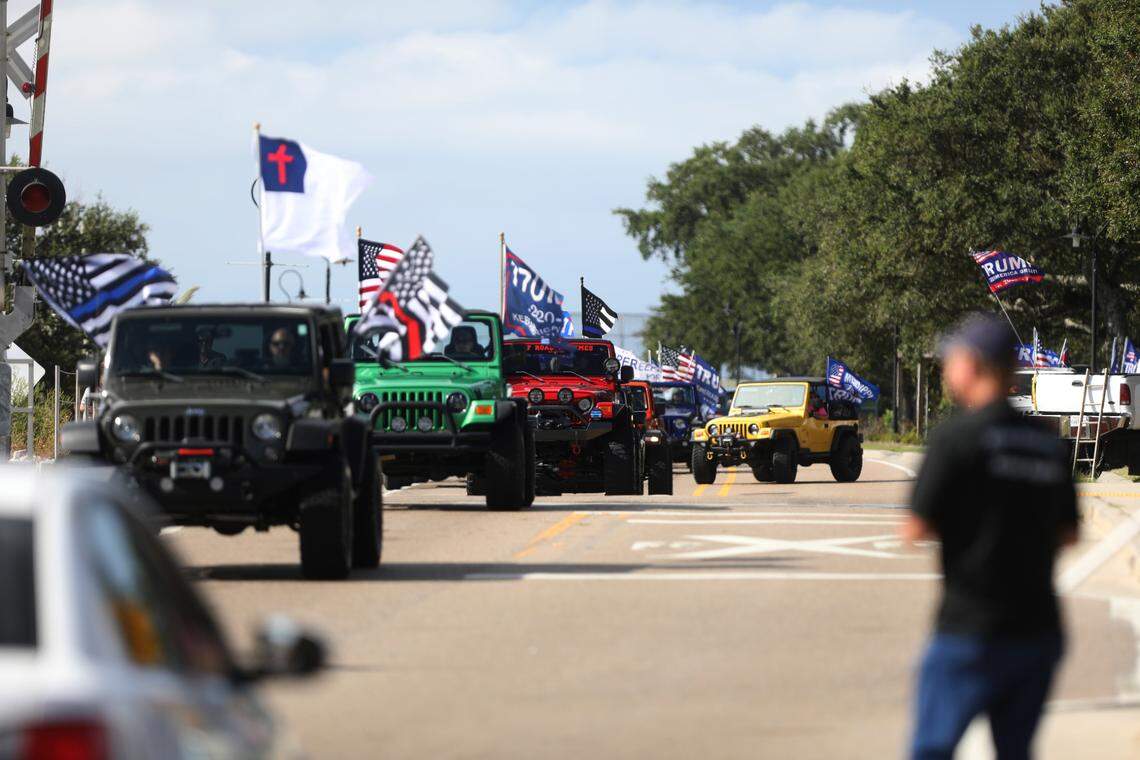 Spectators wearing “Make America Great Again” clothing and waving flags watched as hundreds of people participated in a Jeep parade supporting President Donald Trump in Bay St. Louis, Mississippi, on Saturday, Sept. 12, 2020.