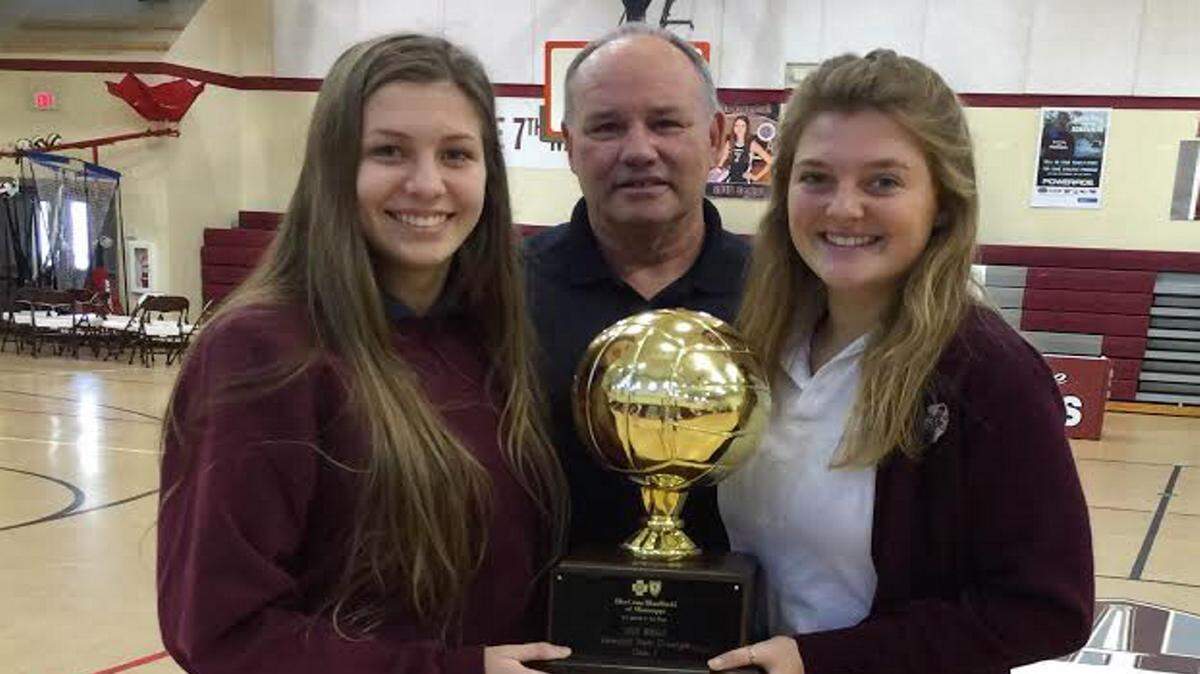 JEFF CLARK/SPECIAL TO THE SUN HERALD 
 Emma Funk, left, and Mary Rimmer join Our Lady Academy volleyball coach Mike Meyers in celebrating the team's championship season. The Crescents won their fourth straight state title in Class I volleyball.