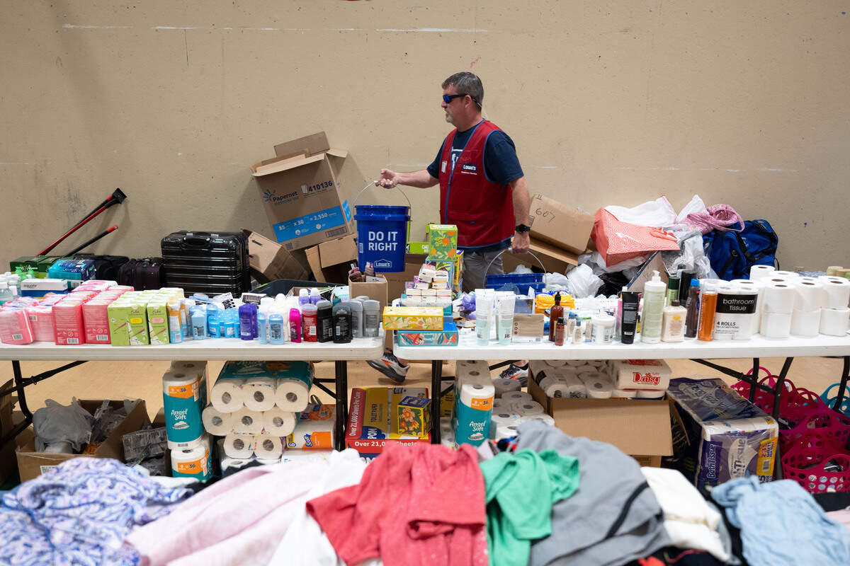 Lowe’s workers carry in free buckets June 24 at the LaVay Crawley Memorial Life Center in Wiggins.